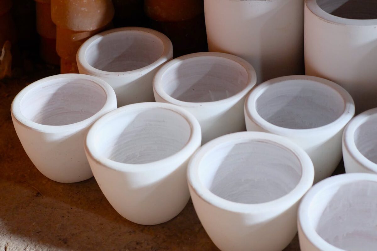 Close-up of handcrafted ceramic pots in a traditional workshop, showcasing West Java craftsmanship.